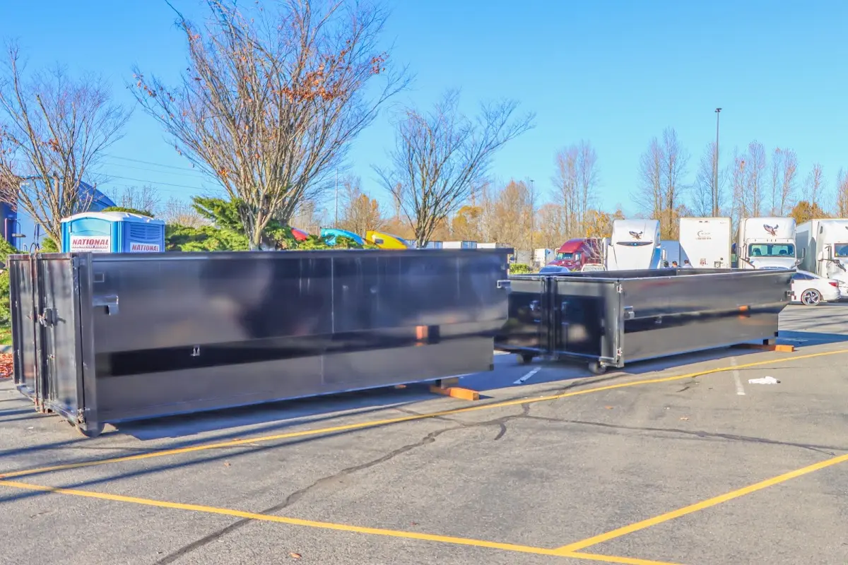 Professional dumpster rental service with roll-off container on residential driveway in Surf City